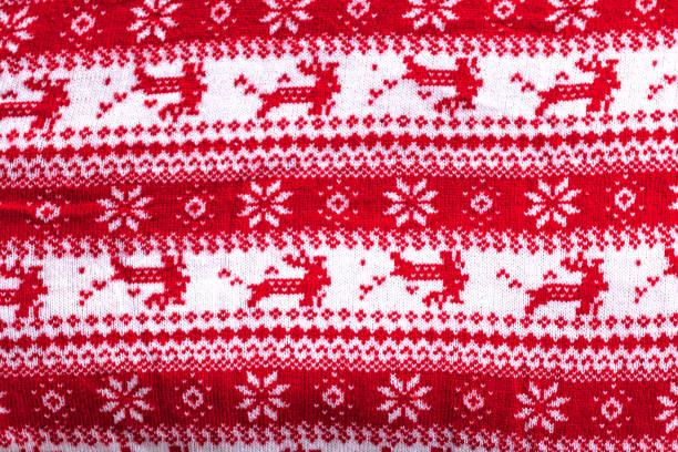 istock Real red knitted background with white Christmas deer and snowflakes 1193108155