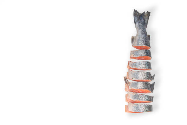 Raw salmon cut into pieces isolated on white background
