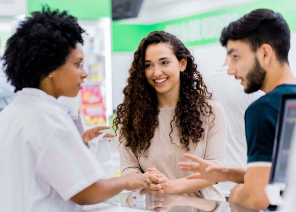 istock Customers discussing with chemist in drugstore 1193113210