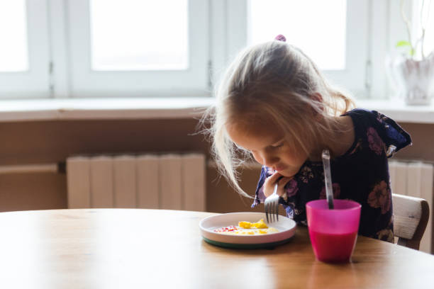 istock Confident girl with disability eats breakfast in her home 1193113881
