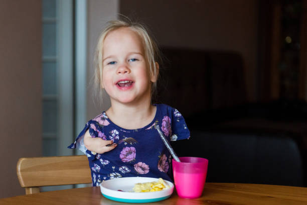 istock Independent girl with disability enjoys her breakfast 1193113887