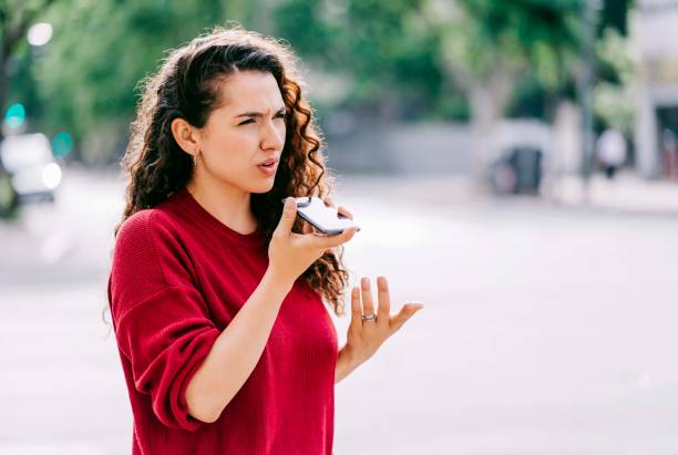 woman with neck injury using smart phone on street - conference phone imagens e fotografias de stock