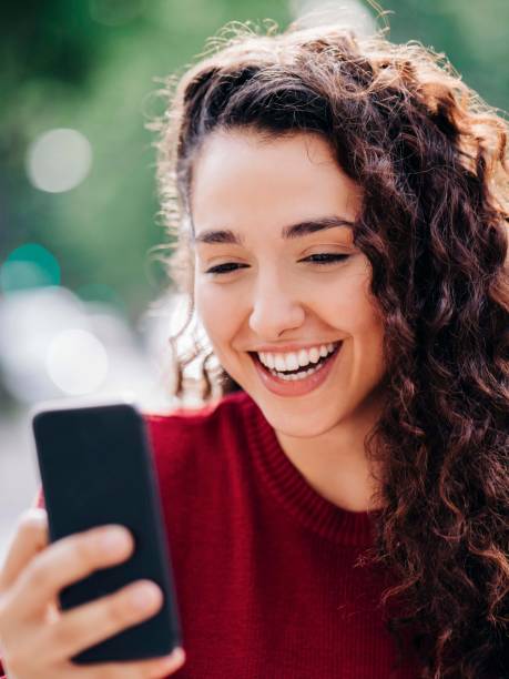 istock Happy woman video calling through mobile phone 1193114255