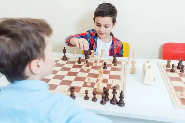 Photo of Family playing chess in tournament room