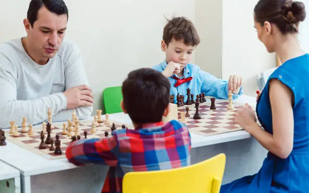 Photo of People playing a chess tournament