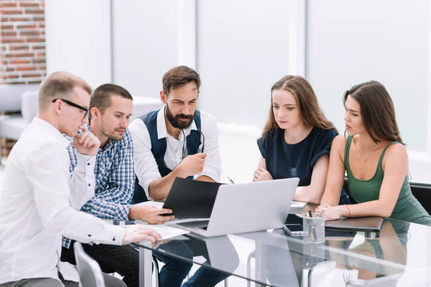 istock business team sitting at the office Desk 1193117254