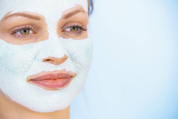 istock Girl with dry white mud mask on face 1193118698