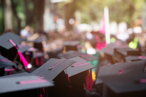 istock Group of Graduates during commencement. Concept education congratulation in University Degree. Graduation Ceremony 1193120601