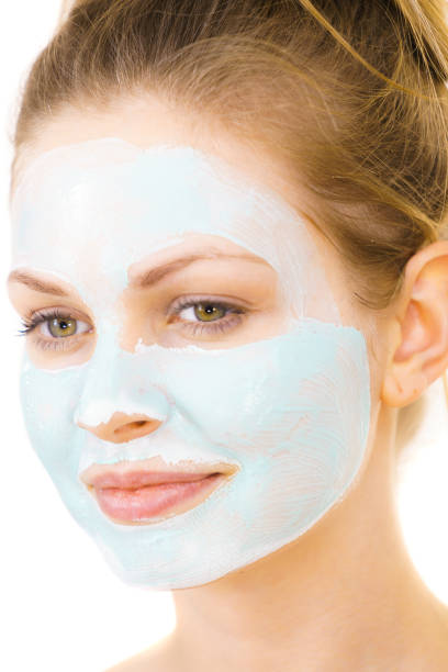 istock Girl with green mud mask on face 1193121452