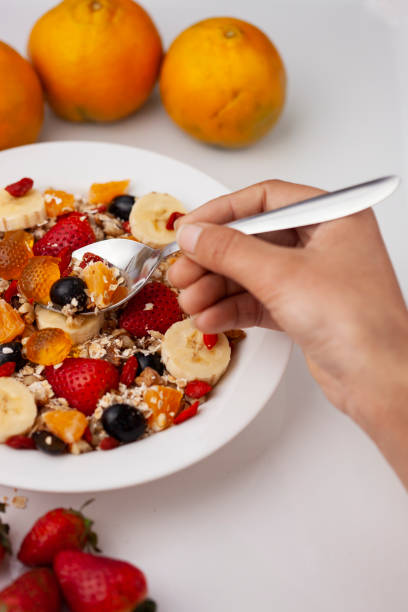 istock Close-up of hand taking oats from a plate through spoon. 1193121778