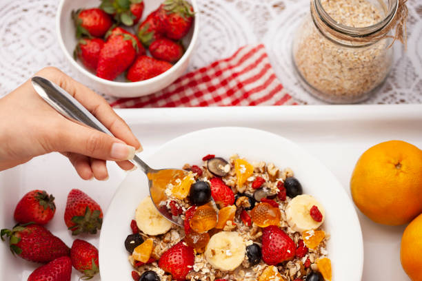 istock Close-up of hand taking oats from a plate through spoon. 1193121784