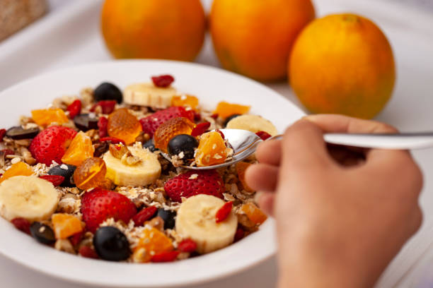 istock Close-up of hand taking oats from a plate through spoon. 1193121788