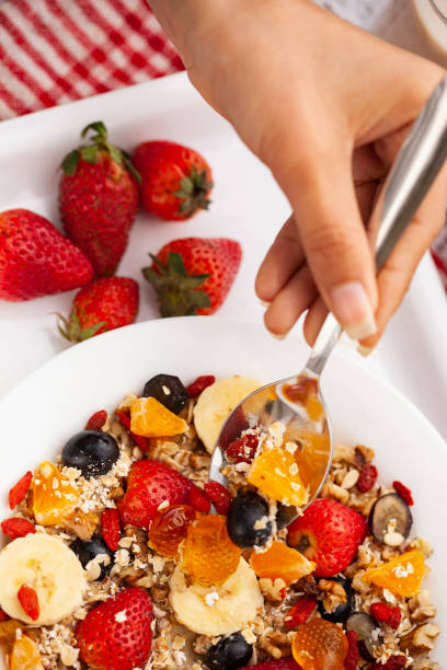 istock Close-up of hand taking oats from a plate through spoon. 1193121794