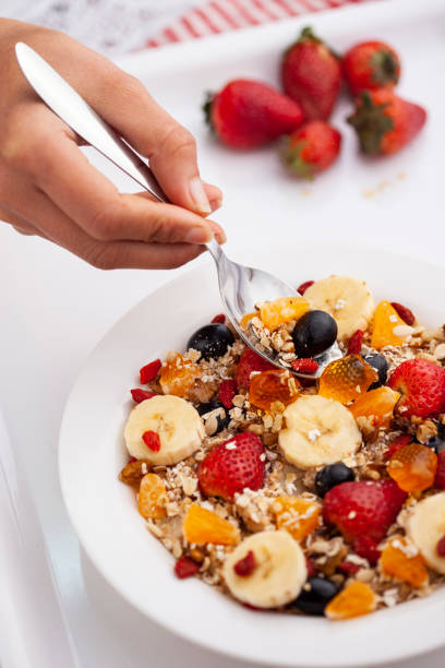 istock Close-up of hand taking oats from a plate through spoon. 1193121798