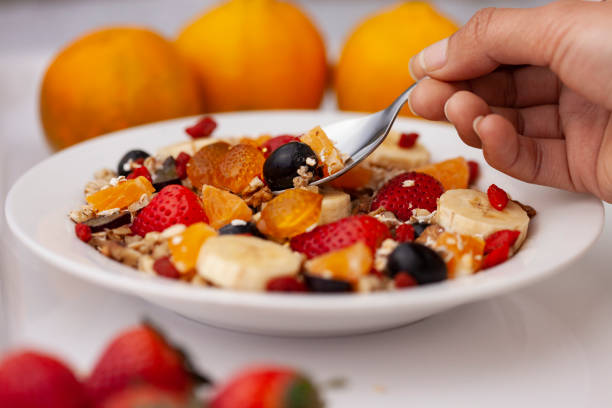 istock Close-up of hand taking oats from a plate through spoon. 1193121799