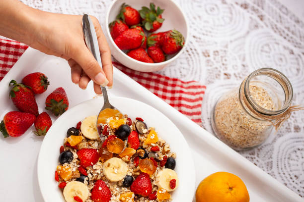 istock Close-up of hand taking oats from a plate through spoon. 1193121801