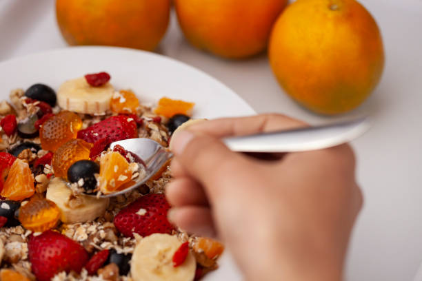 istock Close-up of hand taking oats from a plate through spoon. 1193121828