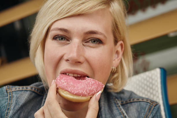istock Beautiful woman eating chocolate cake at cafe 1193122425