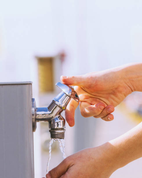 istock Woman drinking water from street tap 1193123151