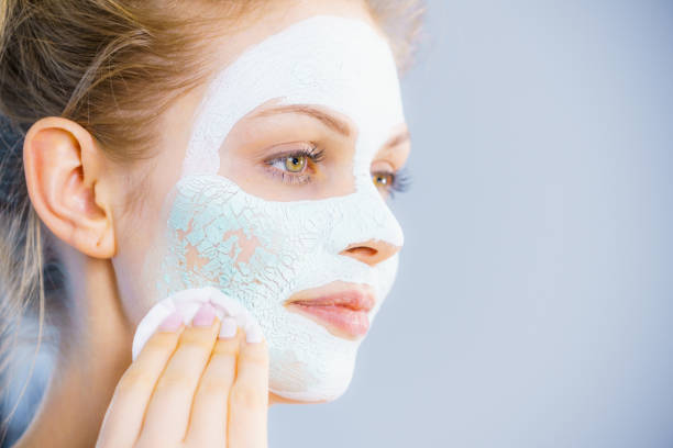 istock Girl removes dry white mud mask 1193123352