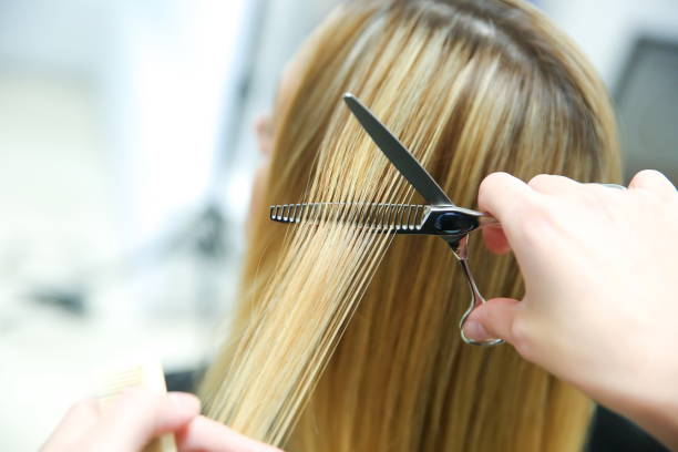 istock barber hand cuts hair close up 1193124681
