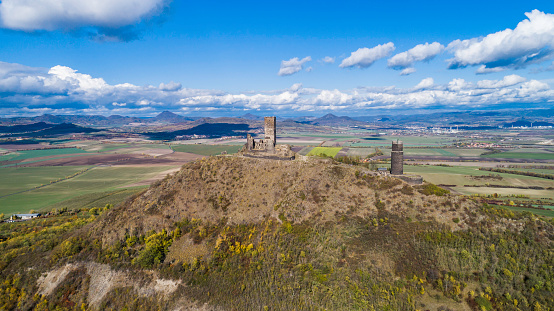 Hazmburk is a mountain peak in the Ceske Stredohori range found in the Czech Republic. \nAt the top of the mountain there is the ruin of a mediaeval castle, of which two towers and some wall fragments.