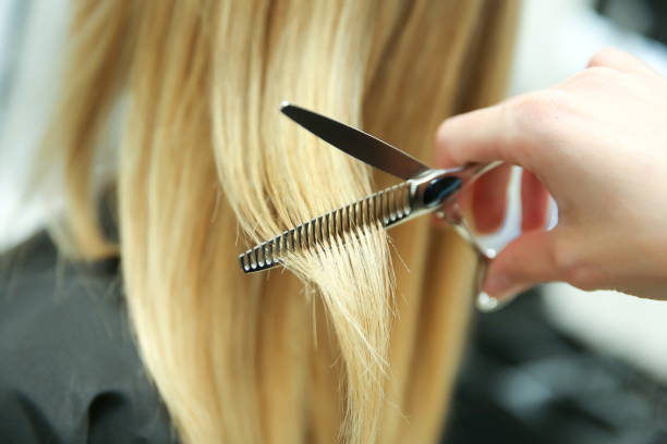 istock barber hand cuts hair close up 1193125576