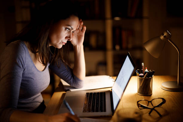 istock Woman working late at home 1193125685