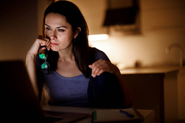 istock Woman working on laptop late at home 1193125816