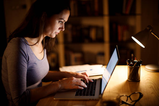 istock Woman working on laptop late at home 1193126086