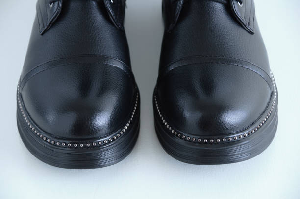 istock The toe of black boots close-up. White background. 1193127265