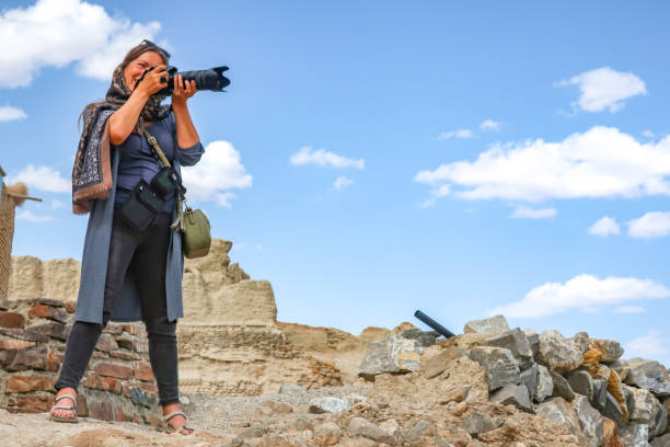 Mature Woman Tourist Photographer in Middle Eastern Country Mature Woman Tourist Photographer in Middle Eastern Country. muslim photographer stock pictures, royalty-free photos & images