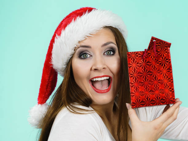 istock Happy Christmas woman holds gift bag 1193127821