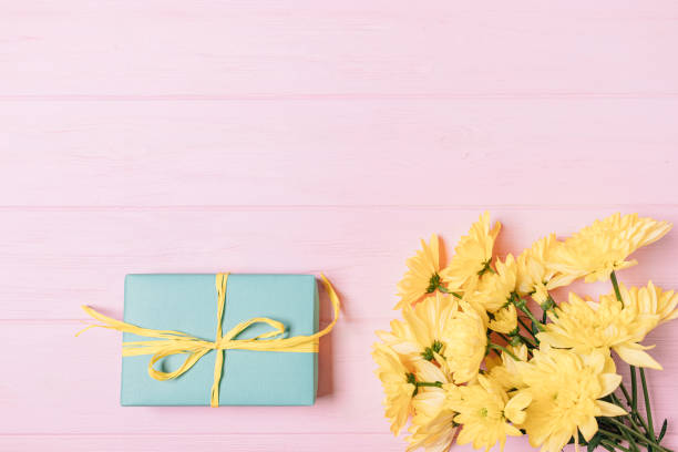 istock Gift box next to bouquet of fresh flowers 1193128749