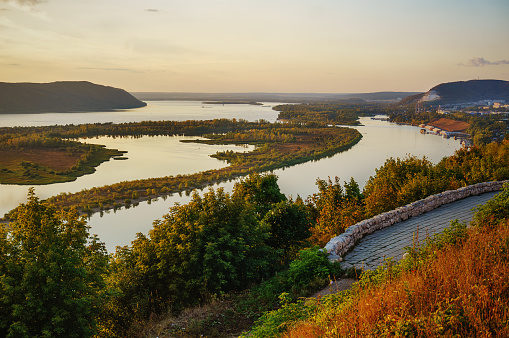 View of the Volga River from an observation platform near Samara, golden sunset over the Zhigulev mountains.