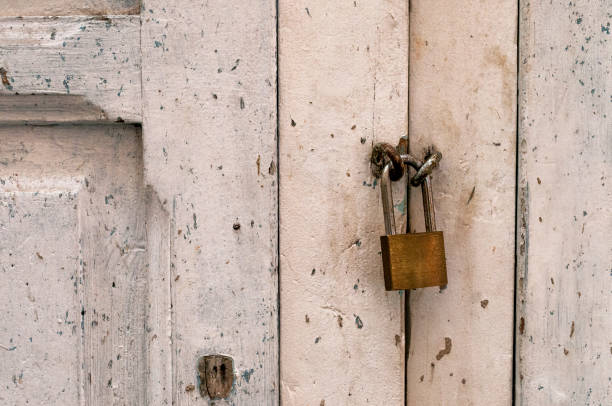 istock Old metal lock on a white wooden door 1193129904