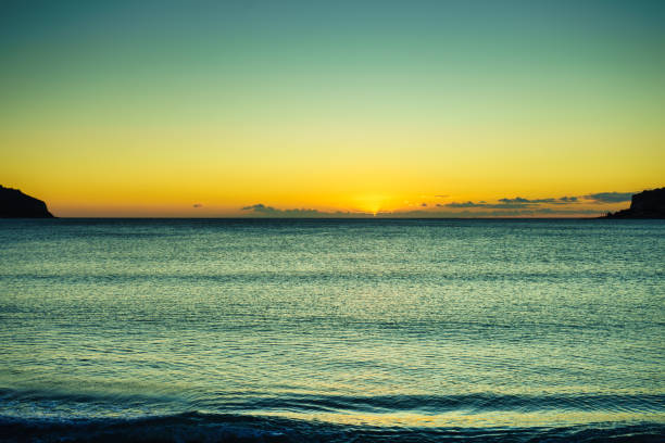 Seashore in the evening. Sunset over the sea. Beautiful beach with dramatic sunset sky