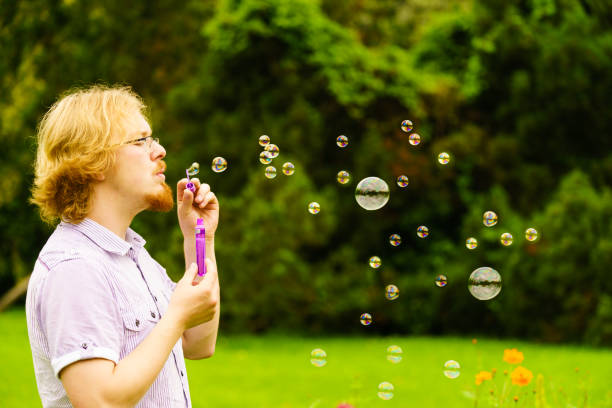 istock Man blowing soap bubbles outdoor 1193133230