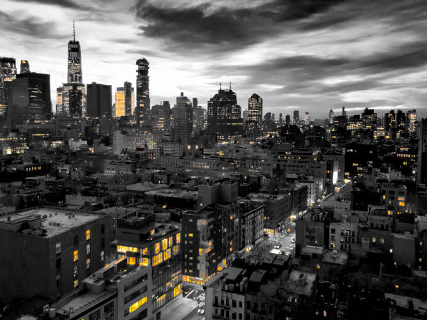 New York City skyline view at night with yellow lights contrasted against the black and white buildings New York City skyline view at night with yellow lights contrasted against the black and white buildings of lower Manhattan film noir style photos stock pictures, royalty-free photos & images