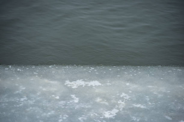 ice and water in the river in cloudy weather. In the countryside. Early spring, March. Web banner.