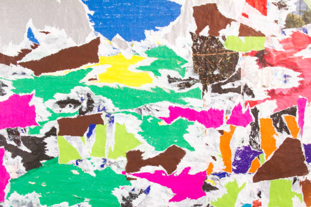 istock Torn and peeling pieces of paper posters on billboard with rough surface texture background. 1193138600