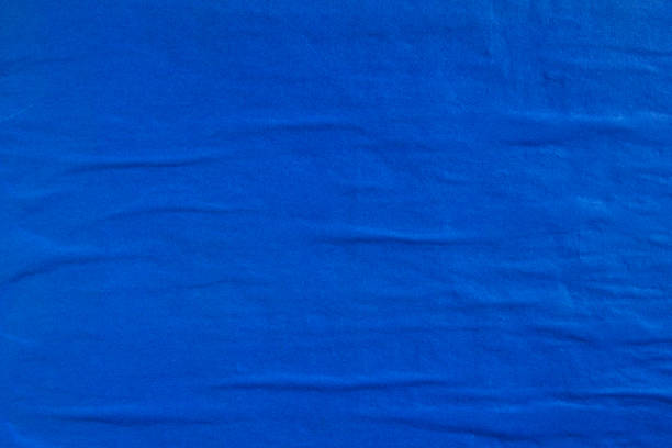 istock Closeup dark blue wavy gloss paper posters on billboard with rough surface texture background. 1193138606
