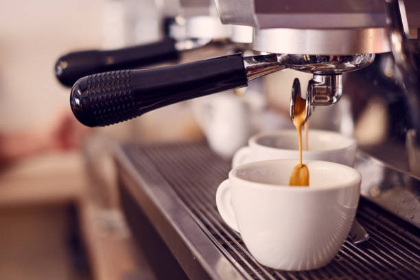 istock Close up of pouring espresso into two white cups 1193138835