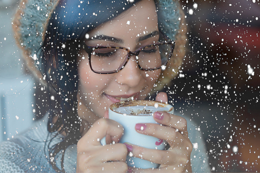 Woman enjoying her coffee on a snowy day