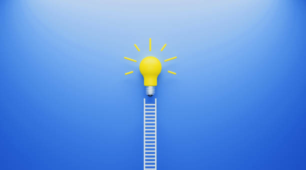 istock White Ladder and Yellow Lightbulb Leaning on Blue Wall 1193139658