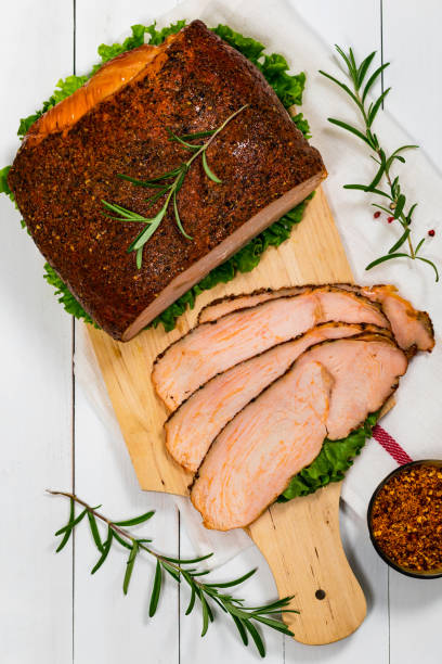 Roasted Turkey Breast Cajun Style Deli Lunch Meat Roasted Turkey Breast Cajun Style Deli Lunch Meat on White Wooden Background. Selective focus. turkey breast stock pictures, royalty-free photos & images