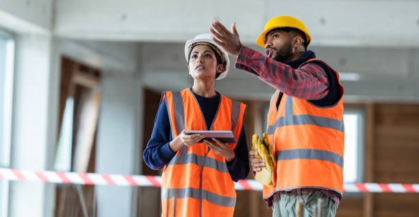 istock Female Architect And Construction Foreman Talking At A Construction Site 1193140258