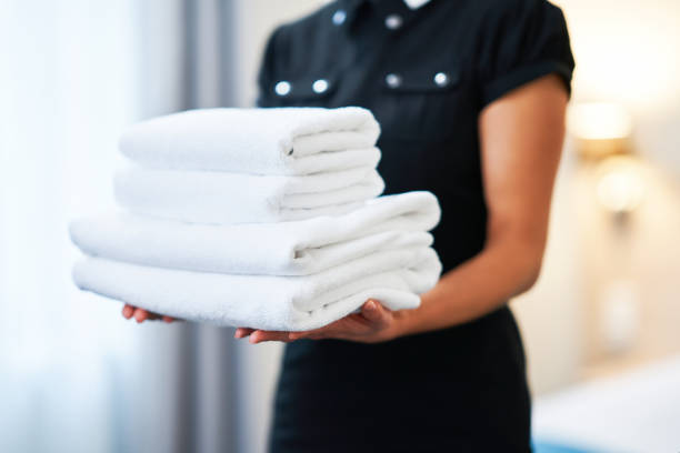 istock Maid with fresh towels in hotel room 1193141357
