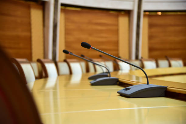 istock Microphones on a round table for negotiations 1193141383