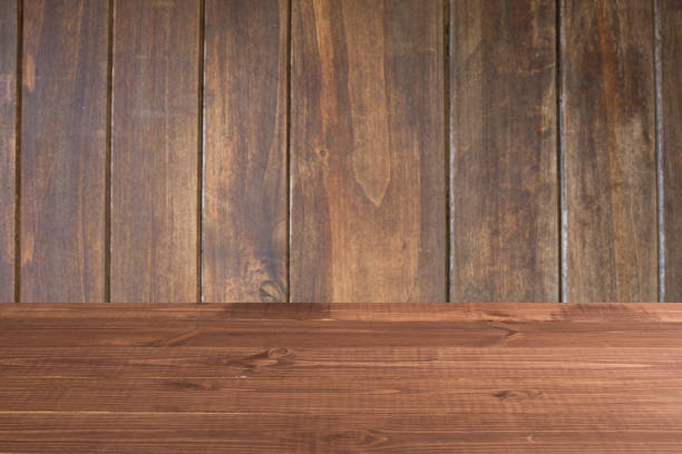 istock Wooden board empty table in front of a blurred background. Perspective brown wood over blurred wooden planks background - can be used to showcase or assemble your products. Mock up 1193141591